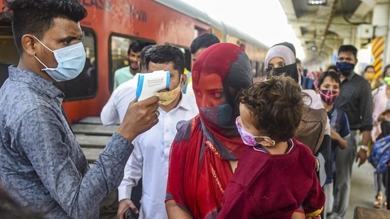 A BMC health worker conducts thermal screening of outstation passengers at Dadar Railway Station in Mumbai. The Centre has directed states and Union territories to increase Covid-19 testing. (PTI)