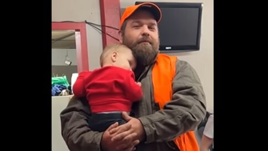 The man holding the baby boy who refuses to let go. (instagram/@maryalyssacarr) The man holding the baby boy who refuses to let go. (instagram/@maryalyssacarr)