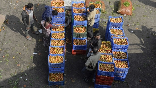 Retail Vendors Check The Quality Of Tomatoes At A Vegetable Wholesale Market In Hyderabad On November 24.(Afp)