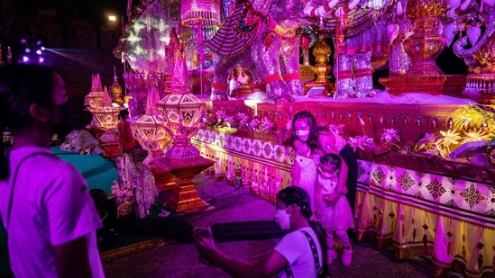 Visitors take photos at Tha Phae Gate during the Loy Krathong festival in Chiang Mai, Thailand.(Bloomberg)