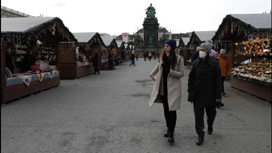 People walk over a nearly deserted Christmas market in Vienna, Austria, Friday, November 19. The most alarming part about soaring numbers through these regions is the fact that nearly all these nations are highly vaccinated (AP) People walk over a nearly deserted Christmas market in Vienna, Austria, Friday, November 19. The most alarming part about soaring numbers through these regions is the fact that nearly all these nations are highly vaccinated (AP)