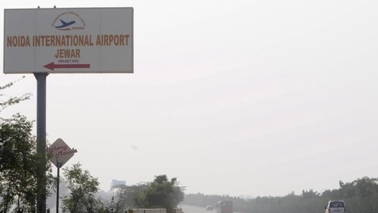 A signboard points towards the Noida International Jewar Airport.(Sunil Ghosh/HT Photo)