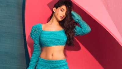 Leaving her luscious tresses open down her back and swept on one side, Nora accessorised her look with a pair of diamond earrings and completed her attire with a pair of Christian Louboutin heels. (Instagram/norafatehi) Leaving her luscious tresses open down her back and swept on one side, Nora accessorised her look with a pair of diamond earrings and completed her attire with a pair of Christian Louboutin heels. (Instagram/norafatehi)