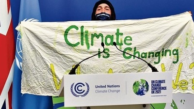 A protester holds a banner during the UN Climate Change Conference (COP26) in Glasgow, Scotland, on November 13. REUTERS A protester holds a banner during the UN Climate Change Conference (COP26) in Glasgow, Scotland, on November 13. REUTERS