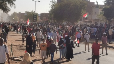 People hold Sudanese flags during a protest, in Khartoum, Sudan. (REUTERS)