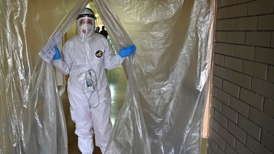 A medical staff wearing personal protective equipment leaves the intensive care unit in one of the hospitals, which treats patients with Covid-19 coronavirus in Kiev. (AFP) A medical staff wearing personal protective equipment leaves the intensive care unit in one of the hospitals, which treats patients with Covid-19 coronavirus in Kiev. (AFP)