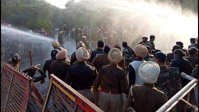 Police using water cannons to stop protesters from marching towards Punjab CM’s residence, in Mohali on Thursday. (HT Photo)