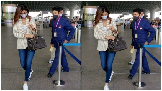 Shilpa Shetty paired a white top and a pair of denims for her airport look.(HT Photos/Varinder Chawla)