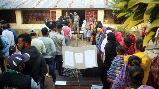 People wait to cast their votes at a polling station during the Tripura municipal corporation elections in Agartala on Thursday. (PTI)