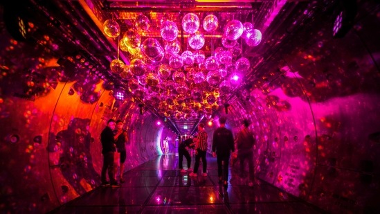 People take pictures inside a decorated tunnel linking a train station to a department store amid the coronavirus disease (Covid-19) pandemic in Bangkok, Thailand