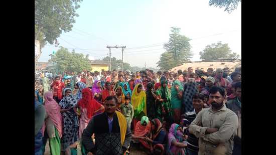 Locals gathered near the crime scene in Mohanganj Gohri village under Phaphamau police station of trans-Ganga area of Prayagraj on Thursday where four members of dalit family were found murdered. (HT photo)