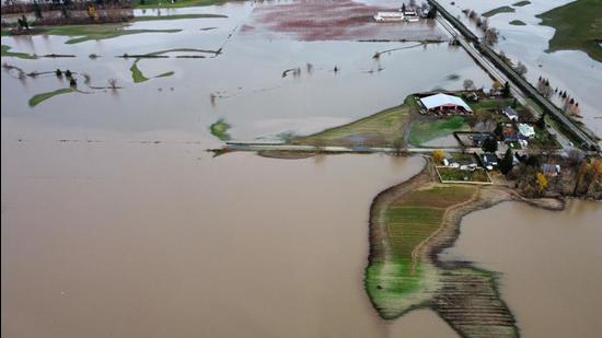 Houses and farms are seen cut off after record rainfall in Abbotsford, British Columbia, Canada on November 17, 2021. (AFP/File)