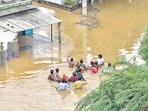Residents wade through a flood-affected area in Nellore district of Andhra Pradesh. (PTI) Residents wade through a flood-affected area in Nellore district of Andhra Pradesh. (PTI)