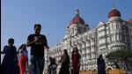 Tourists are seen near the Taj Mahal Palace Hotel, one of the sites of the 2008 terrorist attacks in Mumbai, on Friday. (AFP) Tourists are seen near the Taj Mahal Palace Hotel, one of the sites of the 2008 terrorist attacks in Mumbai, on Friday. (AFP)