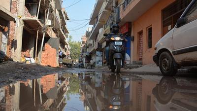 State of wards: Wastewater overflowing from choked stormwater drains inundates the dilapidated streets at Behlana village. (Sant Arora/HT) State of wards: Wastewater overflowing from choked stormwater drains inundates the dilapidated streets at Behlana village. (Sant Arora/HT)