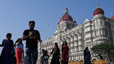 Tourists are seen near the Taj Mahal Palace Hotel, one of the sites of the 2008 terrorist attacks in Mumbai, on Friday. (AFP) Tourists are seen near the Taj Mahal Palace Hotel, one of the sites of the 2008 terrorist attacks in Mumbai, on Friday. (AFP)