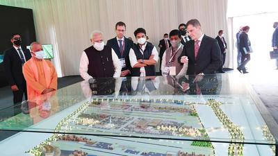 Prime Minister Narendra Modi, along with Uttar Pradesh chief minister Yogi Adityanath, inspecting the design of the Noida international airport before laying the foundation stone of the project at Jewar on Thursday. (PIB) Prime Minister Narendra Modi, along with Uttar Pradesh chief minister Yogi Adityanath, inspecting the design of the Noida international airport before laying the foundation stone of the project at Jewar on Thursday. (PIB)