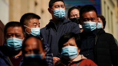 FILE PHOTO: People wearing protective masks are seen on a street, following new cases of the coronavirus disease (COVID-19), in Shanghai, China, November 24, 2021. Picture taken November 24, 2021. REUTERS/Aly Song/File Photo (REUTERS)