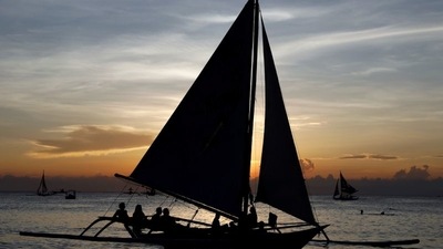 Tourists watch sunset aboard sailboats at holiday island Boracay, in the Philippines. Philippines to reopen borders to some foreign tourists from next week&nbsp; (REUTERS/Erik De Castro)