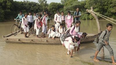 Students get off a boat after crossing the Rind river to reach their school in Fatehpur district, Uttar Pradesh. (PTI/File) Students get off a boat after crossing the Rind river to reach their school in Fatehpur district, Uttar Pradesh. (PTI/File)
