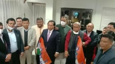 Mukul Sangma and fellow legislators holding a TMC flag while West Bengal minister Dr. Manas Ranjan Bhunia holds the other after the formal handing over of the party flag on Friday. (HT PHOTO.) Mukul Sangma and fellow legislators holding a TMC flag while West Bengal minister Dr. Manas Ranjan Bhunia holds the other after the formal handing over of the party flag on Friday. (HT PHOTO.)