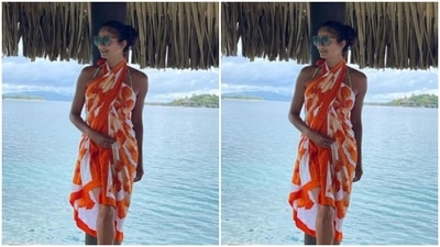 The white pareo is adorned in orange floral prints. (Instagram/@poojabatra)