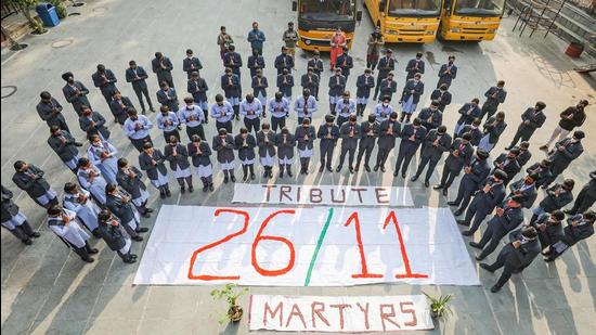 School students pay tribute to martyrs of the 26/11 Mumbai terror attacks, in Jammu on Friday. (PTI)