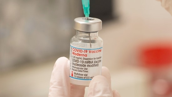 A health care worker fills up a syringe with a dose of Moderna's Covid-19 vaccine for a booster shot at the vaccination reference center at the Epidemiology, Biostatistics and Prevention Institute (EBPI) in Zurich, Switzerland.(Reuters)