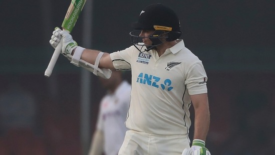 New Zealand's Tom Latham raises his bat after scoring fifty runs during the day two of their first test cricket match with India in Kanpur, India, Friday, Nov. 26, 2021. (AP Photo/Altaf Qadri)(AP)