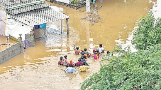 Residents wade through a flood-affected area in Nellore district of Andhra Pradesh. (PTI)