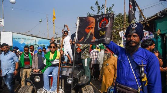 Farmers celebrate at the Singhu border site on Friday. (Amal KS/Hindustan Times)