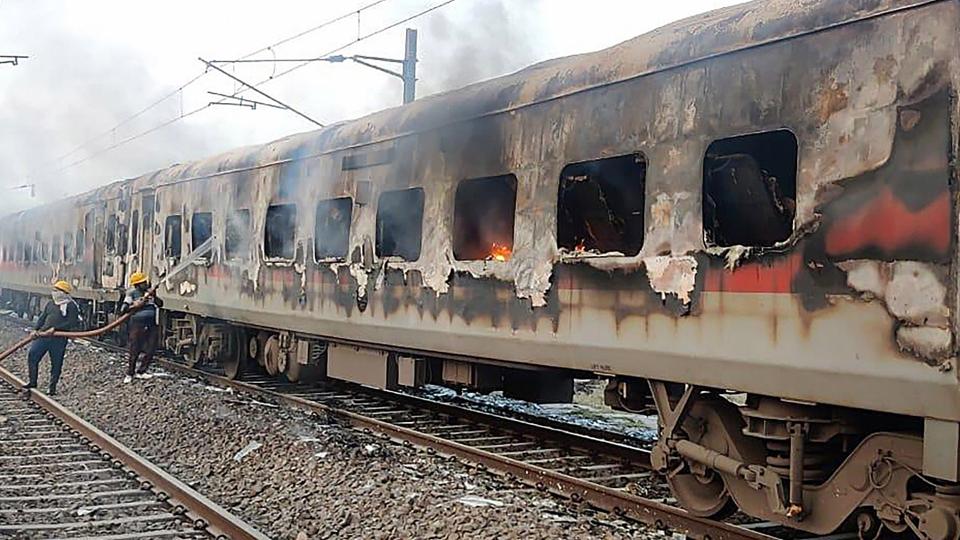 Firefighters douse a fire that broke out inside coaches of Udhampur-Durg express, in Madhya Pradesh’s Morena district (PTI)