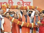 Union Minister Rajnath Singh, UP Chief Minister Yogi Adityanath and UP BJP President Swatantra Dev Singh being garlanded during the 'Booth Adhyaksh Sammelan', in Jaunpur on Saturday. (PTI) Union Minister Rajnath Singh, UP Chief Minister Yogi Adityanath and UP BJP President Swatantra Dev Singh being garlanded during the 'Booth Adhyaksh Sammelan', in Jaunpur on Saturday. (PTI)