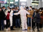 A security guard blocks an exit as he directs people to scan a QR code to track their health status at Shanghai Hongqiao Railway Station, following new cases of the coronavirus disease (Covid-19), in Shanghai, China&nbsp;