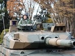 Japan's Prime Minister Fumio Kishida (L) rides on a Japan Ground Self-Defense Force (JGSDF) Type 10 tank during a review at JGSDF Camp Asaka in Tokyo. Japan's Prime Minister Fumio Kishida (L) rides on a Japan Ground Self-Defense Force (JGSDF) Type 10 tank during a review at JGSDF Camp Asaka in Tokyo.