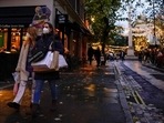 Shoppers carry bags as they wear face masks in the area of Covent Garden, in London.(AP) Shoppers carry bags as they wear face masks in the area of Covent Garden, in London.(AP)