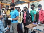 A medic collects swab sample of a passenger for COVID-19 test, in Bengaluru on Saturday. (PTI) A medic collects swab sample of a passenger for COVID-19 test, in Bengaluru on Saturday. (PTI)
