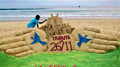 Sand artist Sudarsan Pattnaik makes a sculpture to pay tributes to victims of the 26/11 Mumbai terrorist attacks on its 13th anniversary, in Puri on Friday. (ANI)