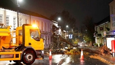 A fallen tree blocks a road after gusts of almost 100 miles (160 km) per hour battered some areas of the country during Storm Arwen, in Norton village, England. (AP)