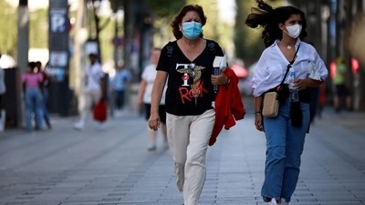 People wearing protective face masks walk on the Champs Elysees Avenue in Paris. (Representative Photo/Reuters)