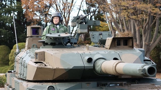 Japan's Prime Minister Fumio Kishida (L) rides on a Japan Ground Self-Defense Force (JGSDF) Type 10 tank during a review at JGSDF Camp Asaka in Tokyo.(AFP) Japan's Prime Minister Fumio Kishida (L) rides on a Japan Ground Self-Defense Force (JGSDF) Type 10 tank during a review at JGSDF Camp Asaka in Tokyo.(AFP)