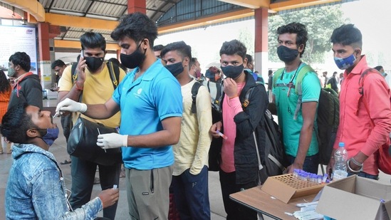 A medic collects swab sample of a passenger for COVID-19 test, in Bengaluru on Saturday. (PTI)