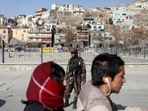 A Taliban fighter stands as he guards a checkpoint in Kabul, Afghanistan.