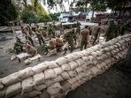 Prime Minister Justin Trudeau visited affected areas on Friday, after deploying the military to help with sandbagging. In picture - Canadian Forces fill sandbags to build a temporary dike behind houses on Clayburn Creek ahead of a rainfall warning in Abbotsford, British Columbia.(AP) Prime Minister Justin Trudeau visited affected areas on Friday, after deploying the military to help with sandbagging. In picture - Canadian Forces fill sandbags to build a temporary dike behind houses on Clayburn Creek ahead of a rainfall warning in Abbotsford, British Columbia.(AP)