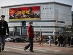 An advertisement of the People's Liberation Army overlooks a street scene.(REUTERS)