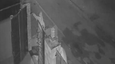 A closed-circuit television camera grab of the incident showing one of the men standing outside the gate and firing gunshots. (HT Photo)