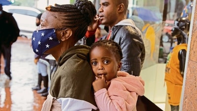 A woman carries a child in Pretoria, South Africa. Scientists in South Africa, where omicron was first identified, are scrambling to combat its spread. (AP) A woman carries a child in Pretoria, South Africa. Scientists in South Africa, where omicron was first identified, are scrambling to combat its spread. (AP)
