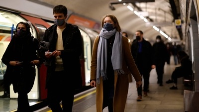 Passengers, many wearing face coverings to combat the spread of Covid-19, walk along a platform as they travel on the London underground in central London. (AFP) Passengers, many wearing face coverings to combat the spread of Covid-19, walk along a platform as they travel on the London underground in central London. (AFP)