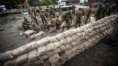 Prime Minister Justin Trudeau visited affected areas on Friday, after deploying the military to help with sandbagging. In picture - Canadian Forces fill sandbags to build a temporary dike behind houses on Clayburn Creek ahead of a rainfall warning in Abbotsford, British Columbia. (AP) Prime Minister Justin Trudeau visited affected areas on Friday, after deploying the military to help with sandbagging. In picture - Canadian Forces fill sandbags to build a temporary dike behind houses on Clayburn Creek ahead of a rainfall warning in Abbotsford, British Columbia. (AP)
