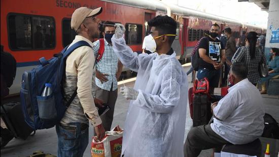 A health worker collects swab samples at Dadar Station in Mumbai. (Bhushan Koyande/HT Photo)